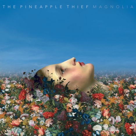 Oben der Text: "THE PINEAPPLE THIEF MAGNOLIA". Eine Frau liegt in einem Feld voller bunter Blumen, in den Himmel blickend.