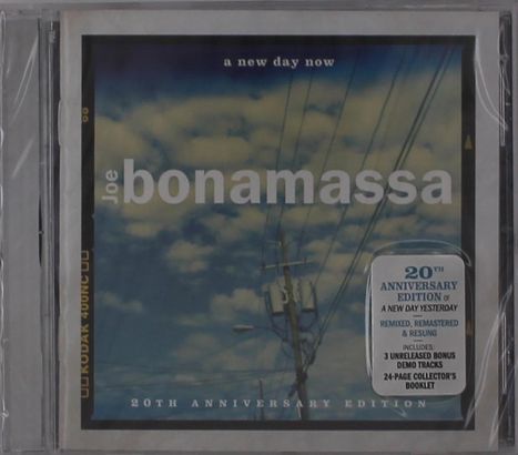 "A new day now", "Joe Bonamassa", "20th Anniversary Edition", blauer Himmel mit Wolken und Stromleitungen im Hintergrund.