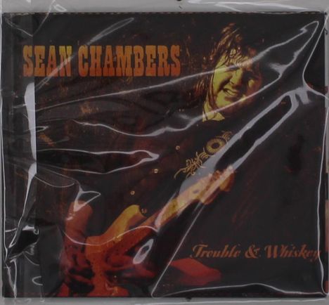 CD-Cover mit den Texten "Sean Chambers" und "Trouble & Whiskey"; zeigt Mann mit Gitarre, in Plastikverpackung.