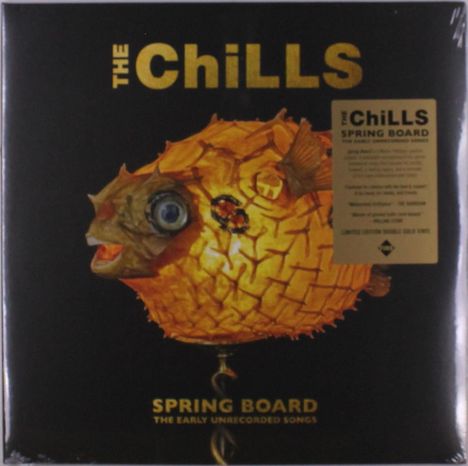 "The Chills," "Spring Board: The Early Unrecorded Songs." Ein Kugelfisch als Lampe illustriert auf dunklem Hintergrund.