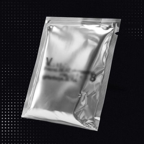 Unleserlicher Text auf einer glänzenden Silberverpackung, schwebend vor einem dunklen, gepunkteten Hintergrund.