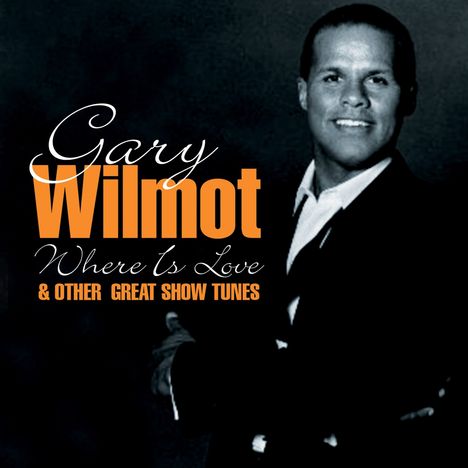 Text: "Gary Wilmot, Where Is Love & Other Great Show Tunes." Ein Mann in einem Anzug lächelt.