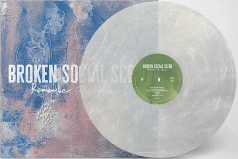 Text "BROKEN SOCIAL SCENE - Remem..." auf einer bunten Hülle neben einer transparenten Schallplatte mit grünem Zentrum.