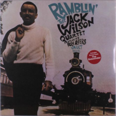 "Ramblin' The Jack Wilson Quartet featuring Roy Ayers." Ein Mann vor einer alten Lokomotive, trägt Pullover und Jacke.