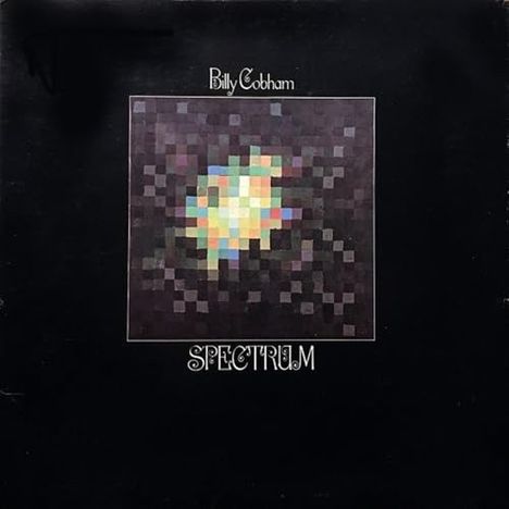 Oben: "Billy Cobham". Unten: "SPECTRUM". Mitte: Bunte, verpixelte Grafik auf schwarzem Hintergrund.
