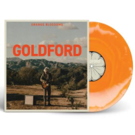 Titel "GOLDFORD" oben "ORANGE BLOSSOMS". Ein Mann mit Gitarre in wüstenartiger Landschaft. Orangefarbene Vinyl-Schallplatte.