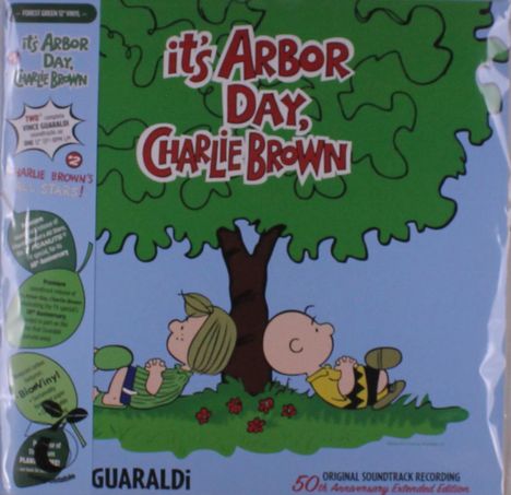 Text: "it's Arbor Day, Charlie Brown" und "GUARALDi". Illustration zweier Figuren unter einem Baum, die sich anlehnen.