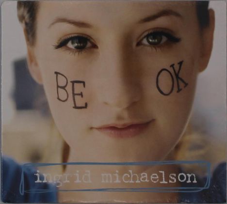 Auf den Wangen steht "BE OK", unten "ingrid michaelson". Ein Gesicht in Nahaufnahme blickt direkt.