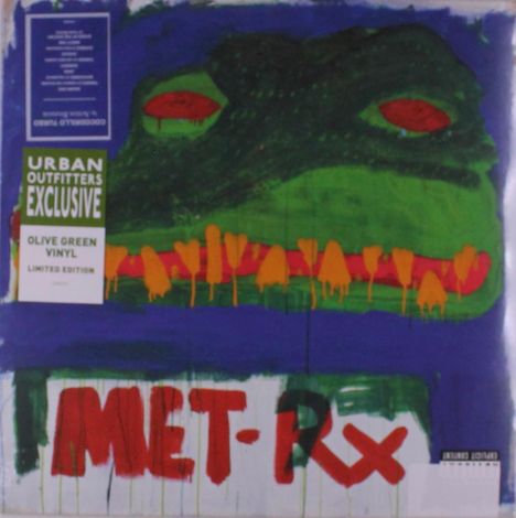 Text: "URBAN OUTFITTERS EXCLUSIVE OLIVE GREEN VINYL LIMITED EDITION" und "MET-Rx". Ein grünes Gesicht mit roten Augen.