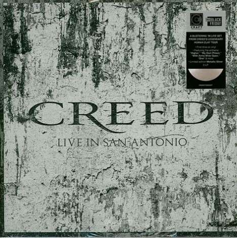Text: "CREED LIVE IN SAN ANTONIO" auf grauem Hintergrund. Oben rechts Aufkleber mit Infos zu exklusivem Vinyl-Set.