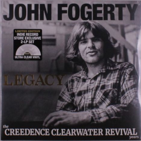 "JOHN FOGERTY", "LEGACY", "the CREEDENCE CLEARWATER REVIVAL years", schwarz-weißes Foto eines Mannes im Holzstuhl.