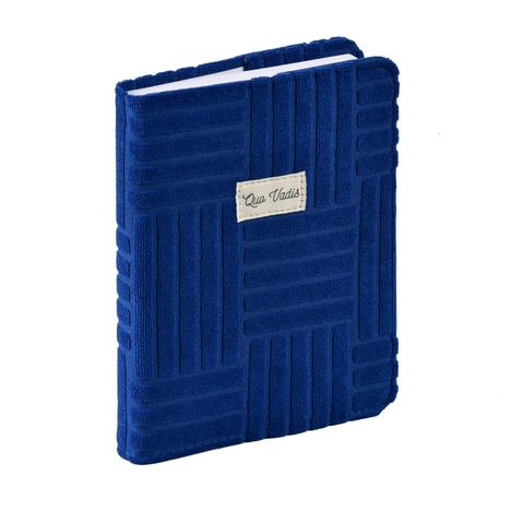 "Quo Vadis" auf weißem Etikett. Blaues, texturiertes Notizbuch mit geometrischem Muster.