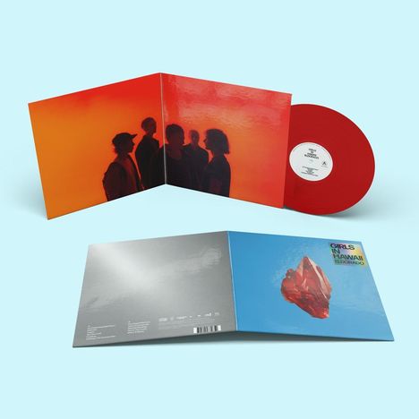 "GIRLS IN HAWAII, ELDORADO." Eine Schallplatte mit rotem Vinyl und einem Album-Cover in Orange- und Blautönen.