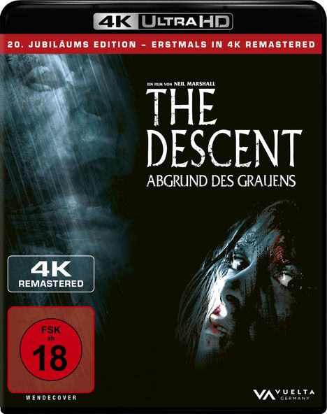 „THE DESCENT: ABGRUND DES GRAUENS“ in weißer Schrift, rot verzierter FSK 18 Hinweis, düsteres Gesicht im Hintergrund.