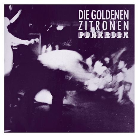 "DIE GOLDENEN ZITRONEN PUNKROCK" steht oben. Verschwommene Schwarz-Weiß-Aufnahme einer energiegeladenen Bühnenszene.