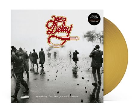 Logo "Jan Delay" in Rot und Gelb. "searching for the jan soul rebels" unten. Menschen laufen durch Rauch, gelbe Vinyl-Schallplatte.
