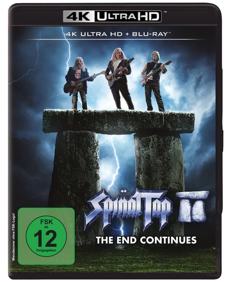 "4K ULTRA HD + BLU-RAY", "Spinal Tap II", "THE END CONTINUES", FSK 12. Drei Gitarristen stehen auf Steinen, Blitz im Hintergrund.
