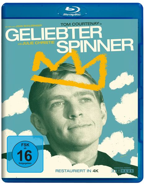 "Geliebter Spinner" in großen Buchstaben. Gelbes Krone-Gekritzel über einem schwarz-weißen Porträt eines Mannes. FSK 16.