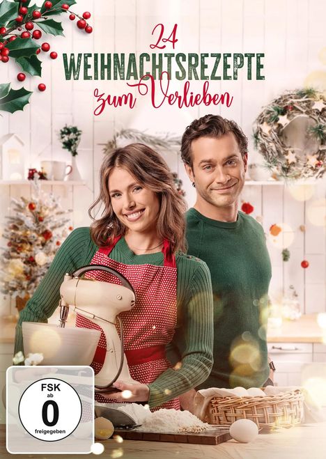 "24 Weihnachtsrezepte zum Verlieben". Zwei lächelnde Menschen in weihnachtlicher Küche, sie mit Schürze und Mixer.