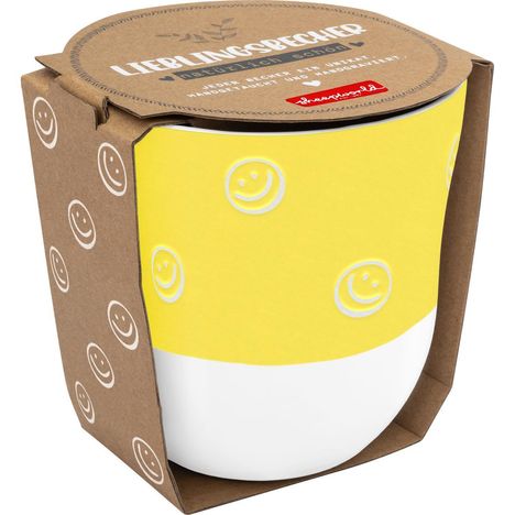 Text "LIEBLINGSBECHER natürlich schön". Gelber Becher mit weißen Smiley-Gesichtern, in brauner Kartonverpackung mit Smileys.