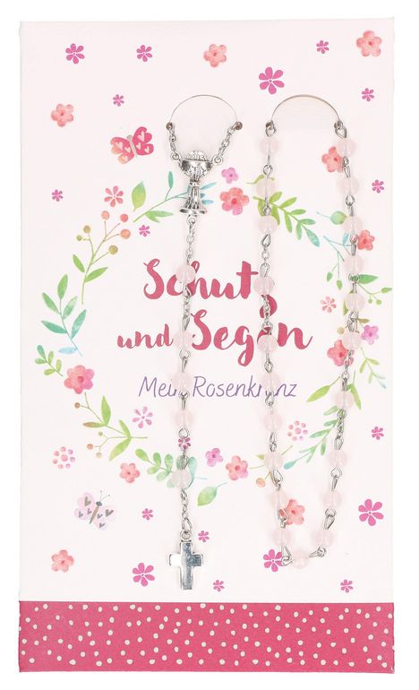 "Schutz und Segen. Mein Rosenkranz." mit Blumenkranz und Schmetterling. Rosenkranz mit Kreuz auf dekorativem Hintergrund.