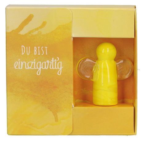 Text: "Du bist einzigartig". Gelbe Verpackung mit gelber, engelartiger Figur in der rechten Hälfte.
