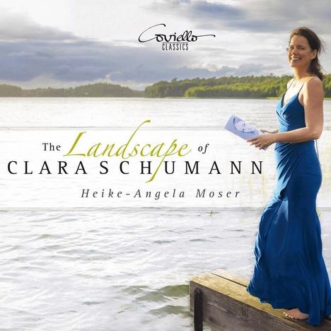 Text: "The Landscape of Clara Schumann. Heike-Angela Moser." Frau im blauen Kleid lächelt, steht an einem Seeufer.