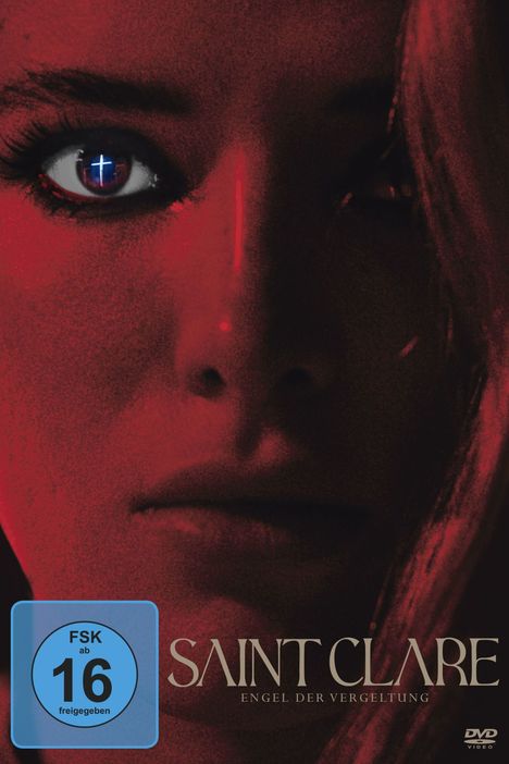 "FSK ab 16 freigegeben" und "SAINT CLARE Engel der Vergeltung" vor Gesicht in Rotlicht, Kreuz im Auge reflektiert.