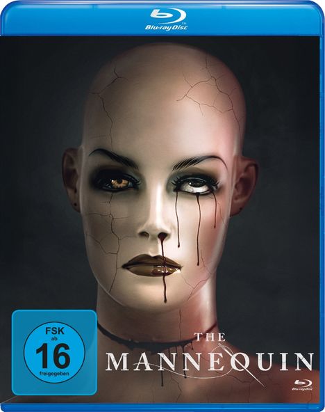 "FSK ab 16 freigegeben", "THE MANNEQUIN". Ein zerbrochenes Puppenkopf-Design mit erschreckendem Ausdruck.