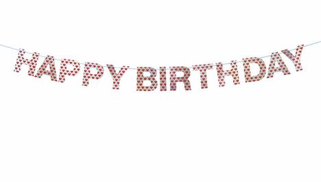 Der Text "HAPPY BIRTHDAY" besteht aus Buchstaben mit roten Herzen, die an einer Schnur aufgehängt sind.