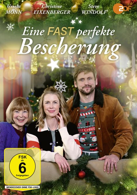 Cover mit dem Text: "Eine FAST perfekte Bescherung", FSK 6. Drei Personen, fröhlich, vor weihnachtlichem Hintergrund.