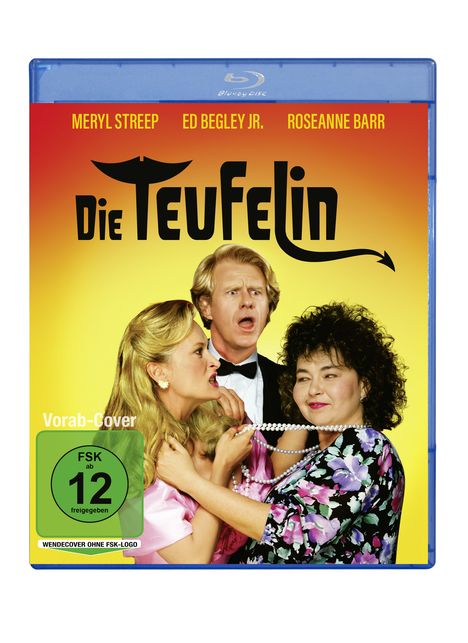"Die Teufelin", Vorab-Cover, FSK 12; Drei Personen: Eine Frau hält Perlenkette, Mann wirkt erschrocken.