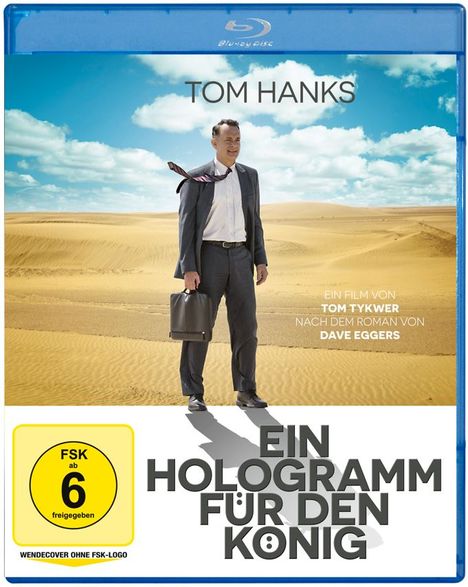 "Tom Hanks. Ein Hologramm für den König. Ein Film von Tom Tykwer nach dem Roman von Dave Eggers." FSK 6. Eine Wüstenlandschaft.