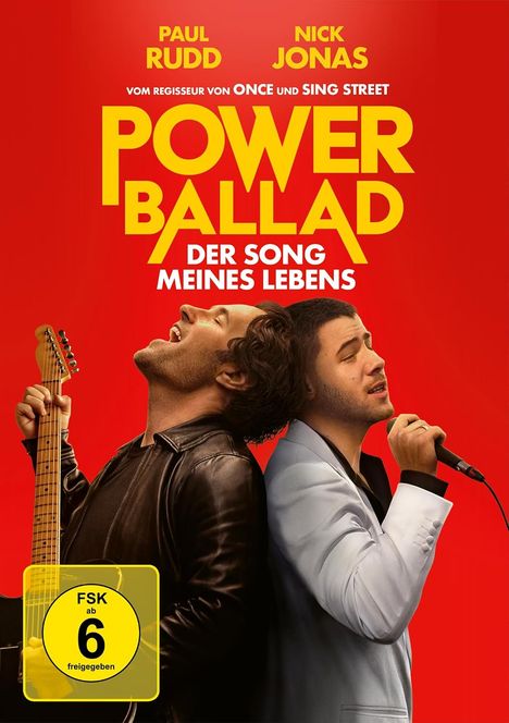 Texte: „MEISTERWERK“, „PAUL RUDD“, „NICK JONAS“, „POWER BALLAD“. Zwei Männer mit Gitarre und Mikrofon auf rotem Hintergrund.