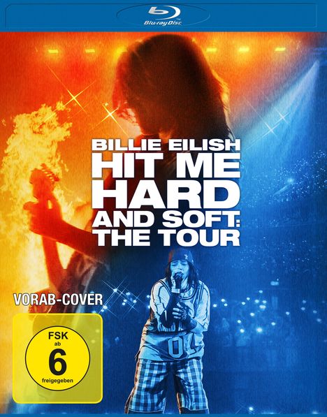 "BILLIE EILISH HIT ME HARD AND SOFT: THE TOUR" in großen Buchstaben, "VORAB-COVER" und "FSK ab 6 freigegeben". Künstler auf Bühne.