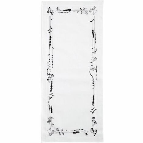 Text fehlt. Ein weißes Tuch mit floralen, schwarzen Stickmustern am Rand.
