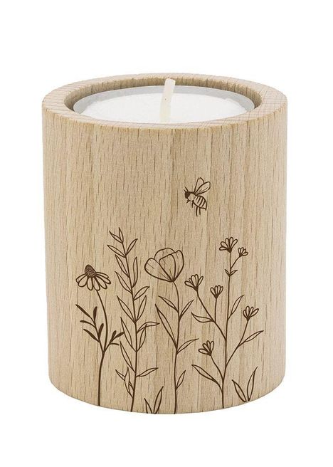 Zylinderförmiger Holzkerzenhalter mit Blumen- und Bienenillustrationen, die in das Holz graviert sind.