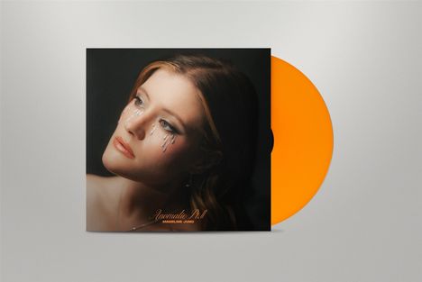 „Anomalie Pt. II - Madeline Juno“, Frau mit glitzernden Tränen, orangefarbene Schallplatte.