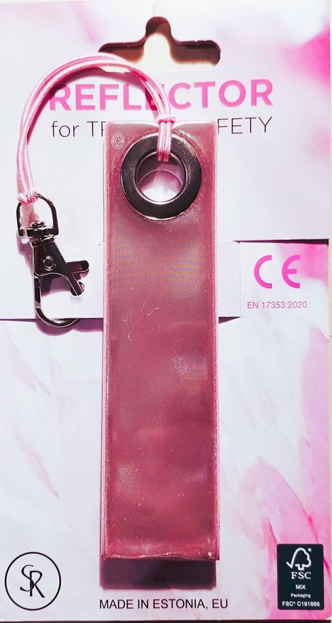 "Reflector for Traffic Safety" und "Made in Estonia, EU". Ein rosa Reflektor mit Karabiner und Band.