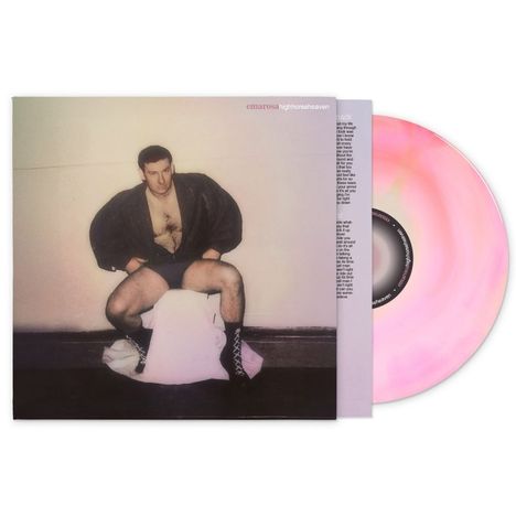 "emarosa highhorseheaven" steht in der Ecke. Ein Mann posiert in schwarzem Mantel und Shorts, mit einem rosa Schallplatte daneben.