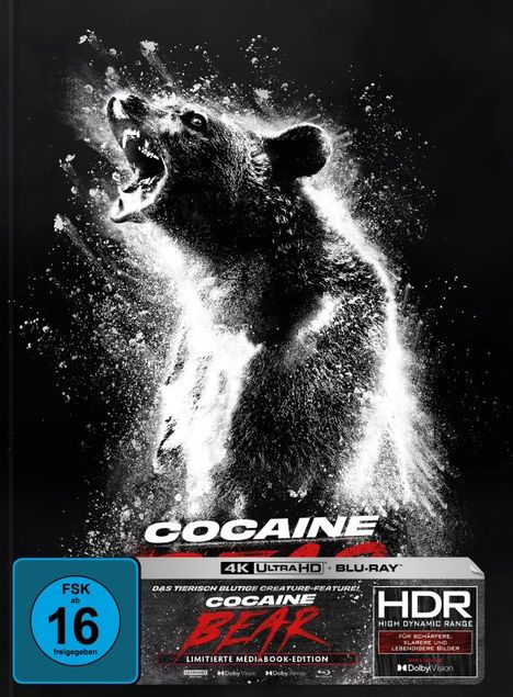 Ein silber-schwarzer Bär brüllt mit offenem Maul, von weißen Spritzern umgeben. "COCAINE BEAR" in fetten Buchstaben unten.