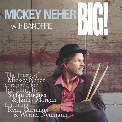 Text: "Mickey Neher BIG! with BANDFIRE. The music of Mickey Neher arranged for big band by Stefan Huefner & James Morgan featuring Ryan Carniaux & Werner Neumann." 

Ein Mann in elegantem Outfit mit Schlagzeugstöcken in der Hand sitzt seitlich.