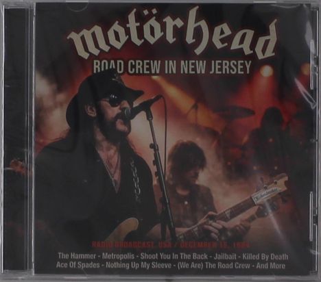 „Motörhead“, „Road Crew in New Jersey“, Musiker auf einer Bühne mit Mikrophon und Gitarre, rockige Atmosphäre.