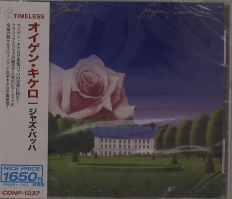 Japanischer Text links, "TIMLESS" und Preis; Illustration: große Rose über einem Gebäude in einer Landschaft.