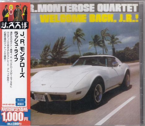"Welcome Back, J.R.!" steht oben, darunter ein weißes Auto auf einer Straße mit Palmen im Hintergrund; links japanischer Text.