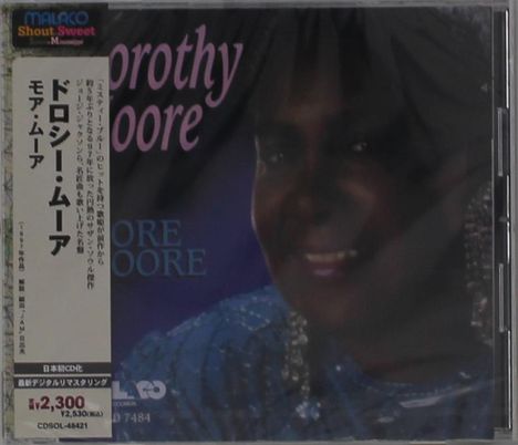 Text: „Dorothy Moore“, „¥2,300“. Eine lächelnde Person in Nahaufnahme. Oben links ein Logo mit „Malaco“.
