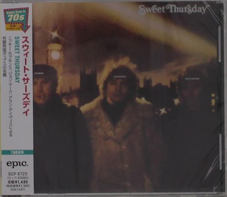 Japanese text along the side, "Sweet Thursday" at the top. Blurry image of three individuals in winter coats.