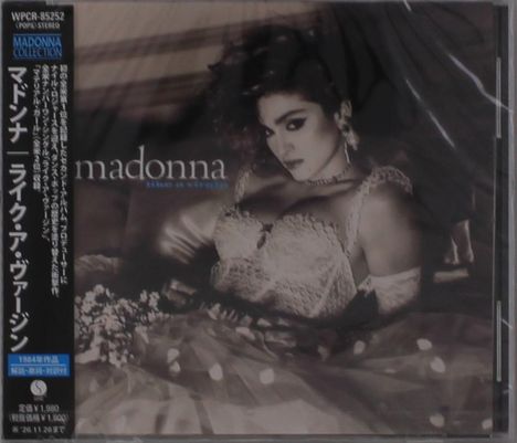 "Madonna Like a Virgin" steht auf der Verpackung. Eine Frau in Spitzenkleid ruht auf einem Bett, detailreich inszeniert.