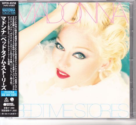 MADONNA, Bedtime Stories. Eine blonde Frau mit rotem Lippenstift und hellem Teint blickt direkt und selbstbewusst.