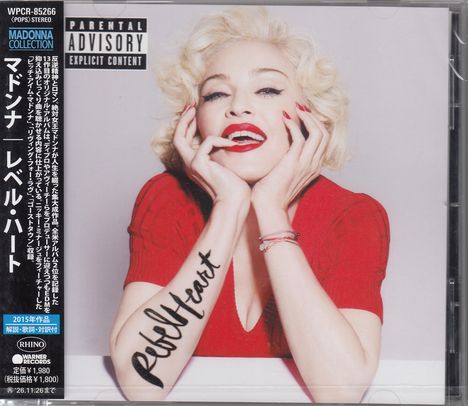Texte: "Parental Advisory Explicit Content", "Rebel Heart". Frau in rotem Kleid, helle Haare, Lächeln, rote Lippen.